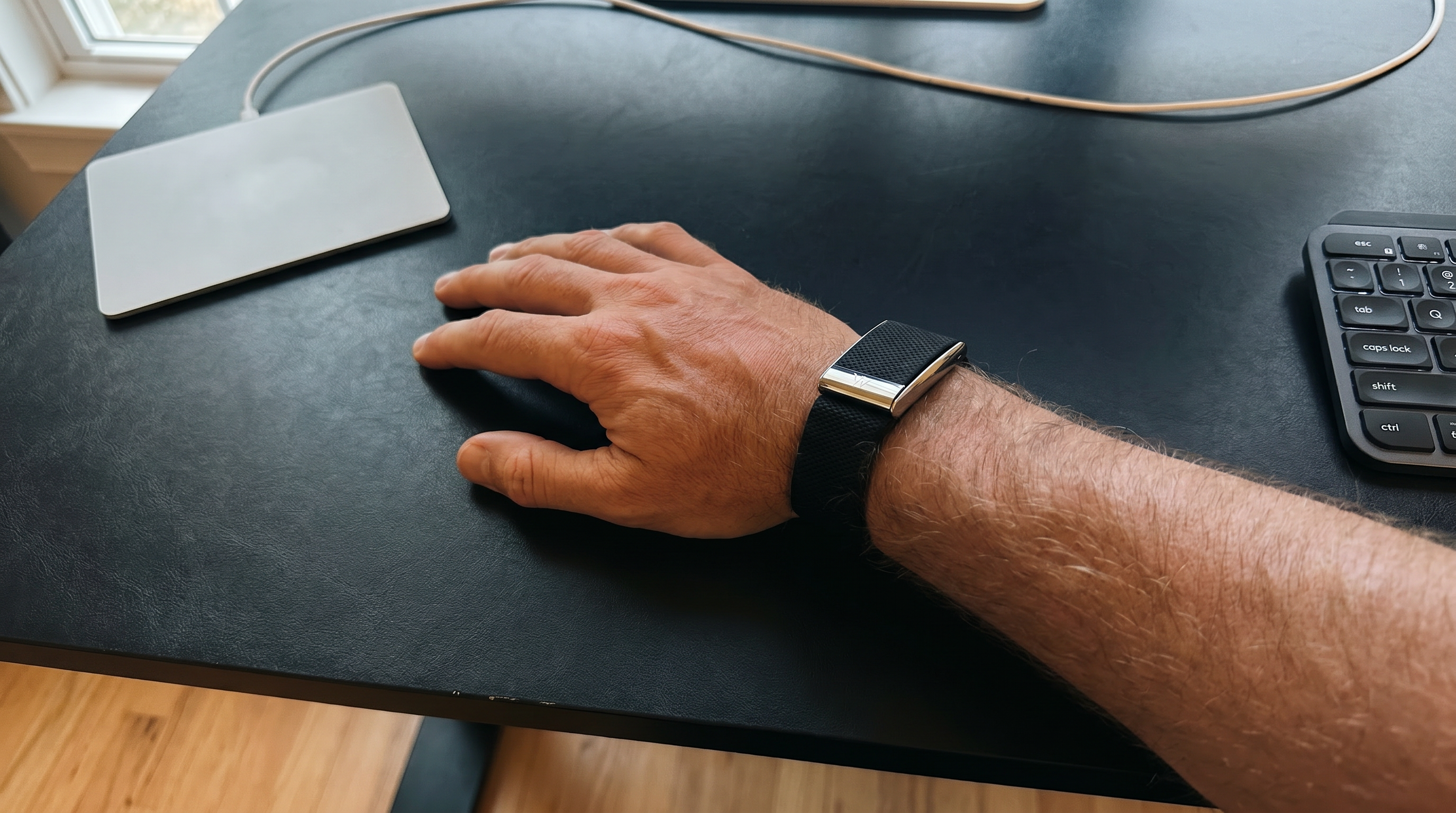 WHOOP band on the right wrist, editorial lighting. Continuous strain, recovery, and sleep.